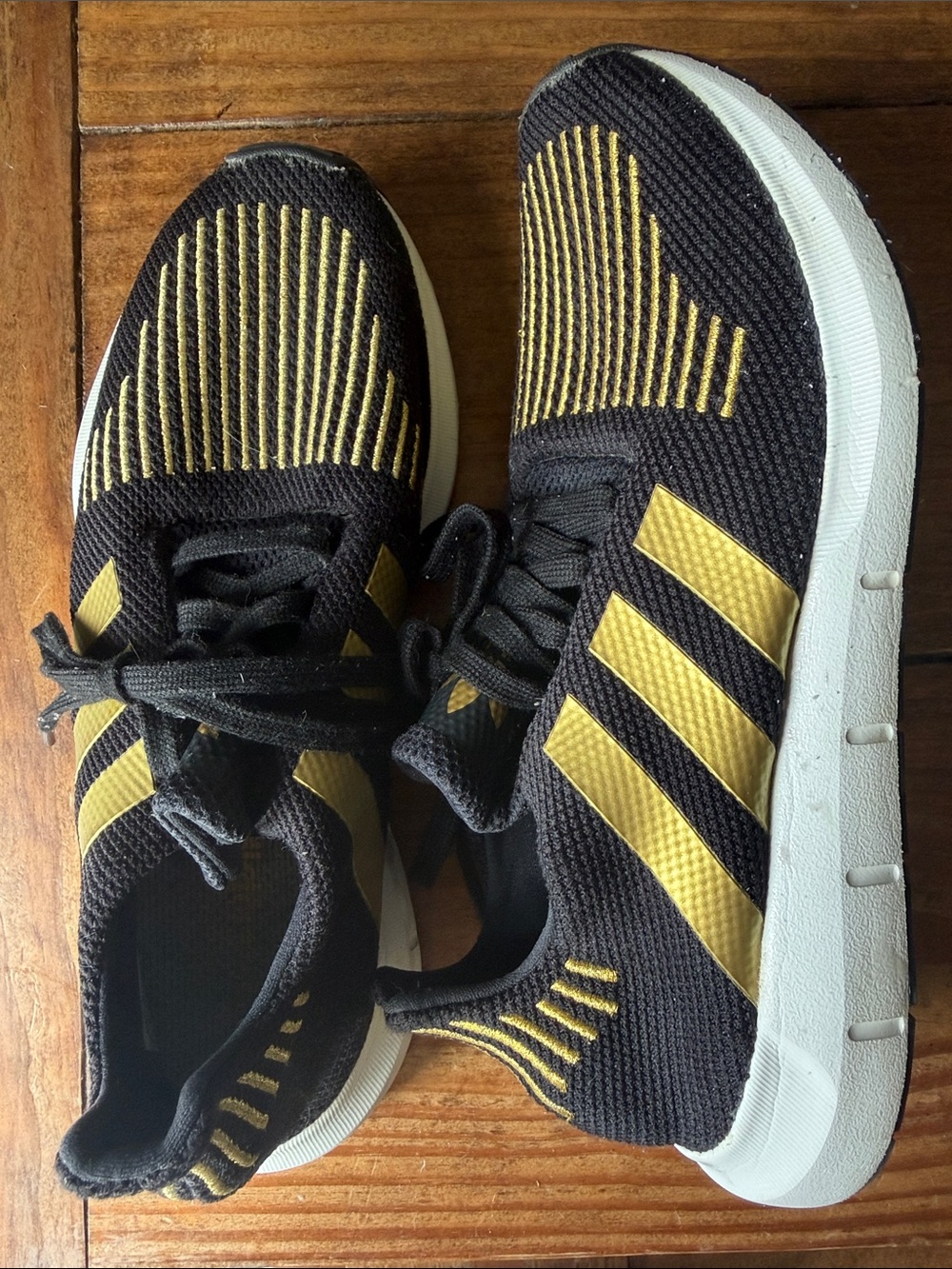 adidas women’s Black and Gold fly Knit Athletic Sneakers